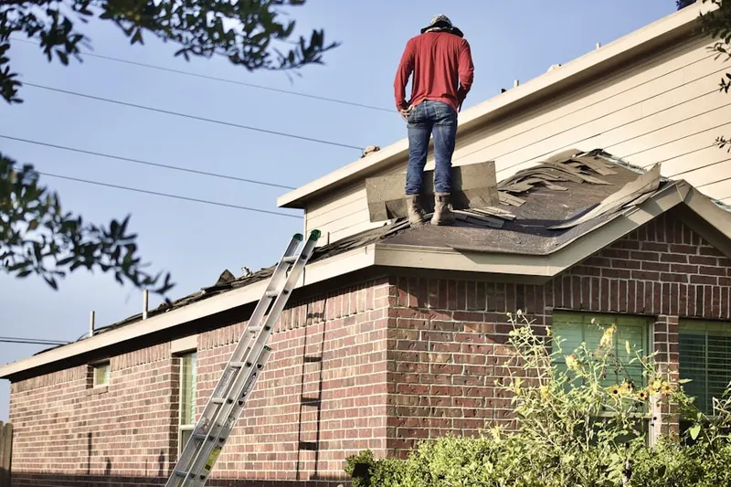 Professional roofer working on a residential roof in Chesapeake Landing